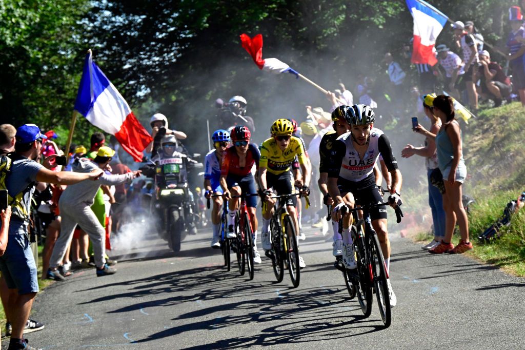 GRAND COLOMBIER FRANCE JULY 14 LR Tom Pidcock of United Kingdom and Team INEOS Grenadiers Jonas Vingegaard of Denmark and Team JumboVisma Yellow Leader Jersey and Adam Yates of United Kingdom and UAE Team Emirates compete in the chase group climbing to the Grand Colombier 1501m while fans cheer during the stage thirteen of the 110th Tour de France 2023 a 1378km stage from ChtillonSurChalaronne to Grand Colombier 1501m UCIWT on July 14 2023 in Grand Colombier France Photo by Bernard Papon PoolGetty Images