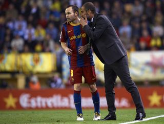 Barcelona coach Pep Guardiola gives instructions to Andres Iniesta in a game against Villarreal in April 2011.