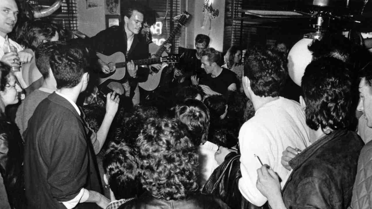 The Clash busking in front of a crowd in 1985