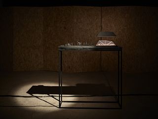 Architectural model on display in dimly lit exhibition space