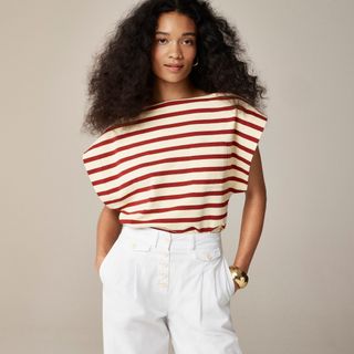 model wears red striped top and white pants 