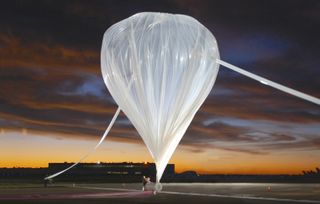 A World View Enterprises balloon undergoes inflation on a runway. A similar balloon is scheduled for a four-day test flight carrying a chicken sandwich.