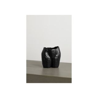 black ceramic vase in female body shape
