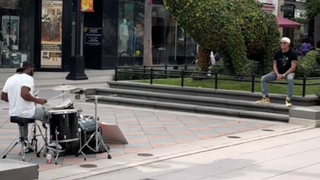 Chad Smith watches a busker drumming to a RHCP song