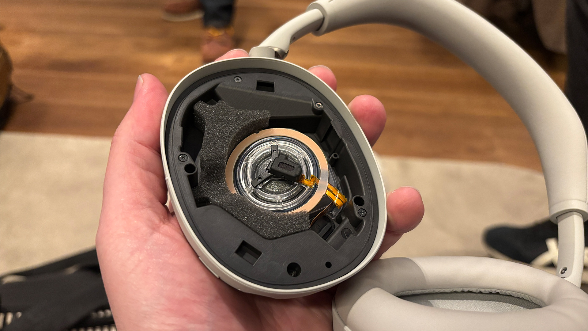 Sony WH-1000XM6 over-ear headphones held in hand showing inside of one earcup