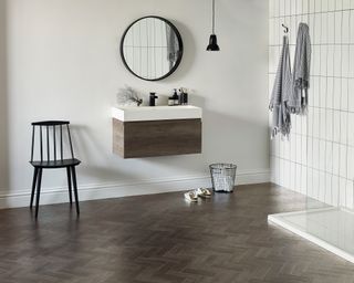 A master bathroom with a white walk-in shower and wood effect luxury vinyl floor tiles