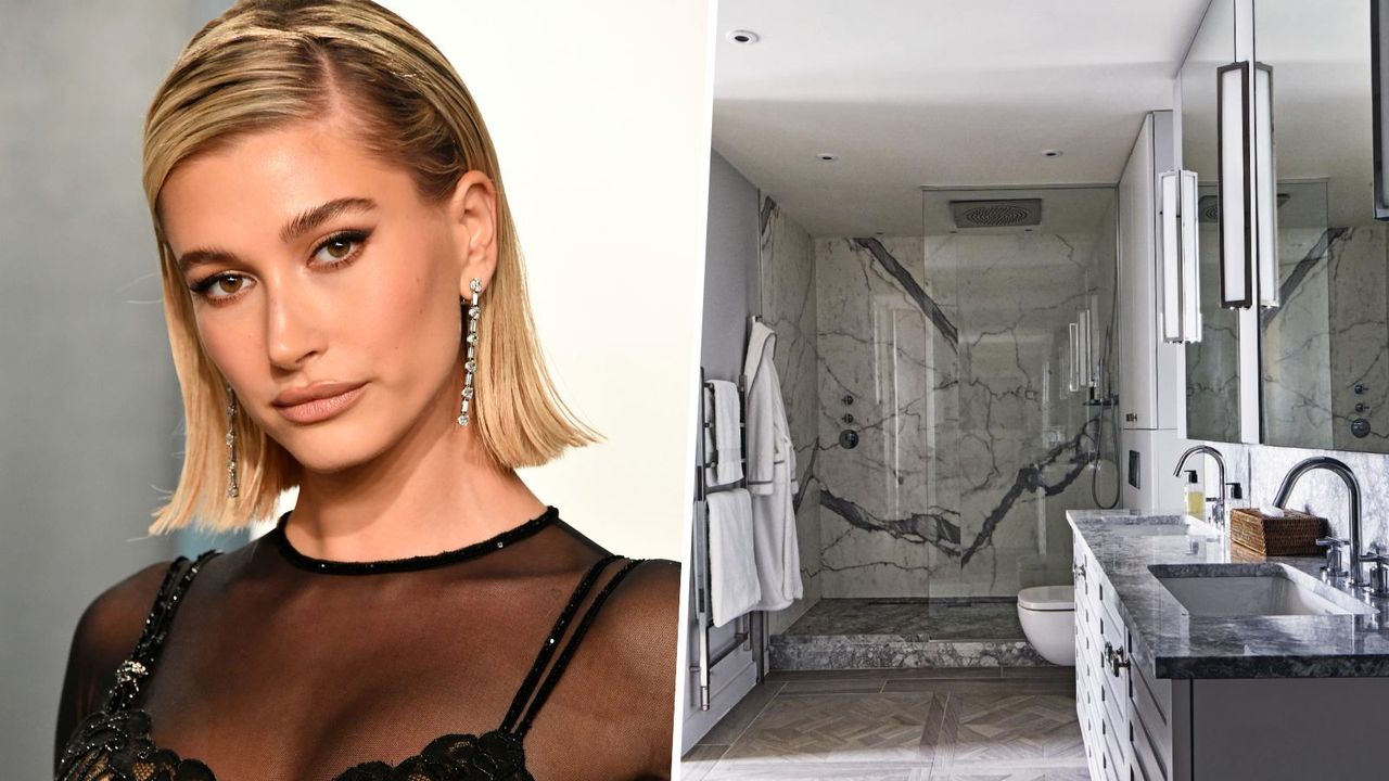 hailey bieber next to dark marble bathroom