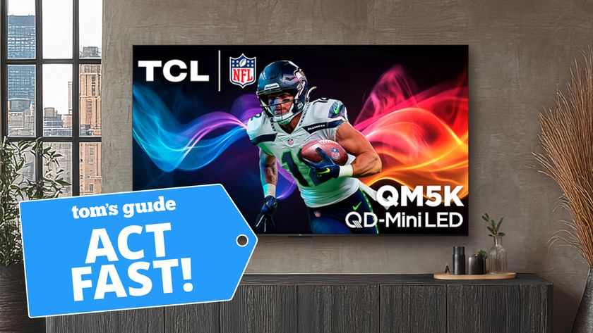 The TCL QM5K Mini-LED TV, wall-mounted in a modern living room setting while displaying an NFL football player. There is a blue-colored badge overlaid on the image that reads: "Tom's Guide. Act Fast!"