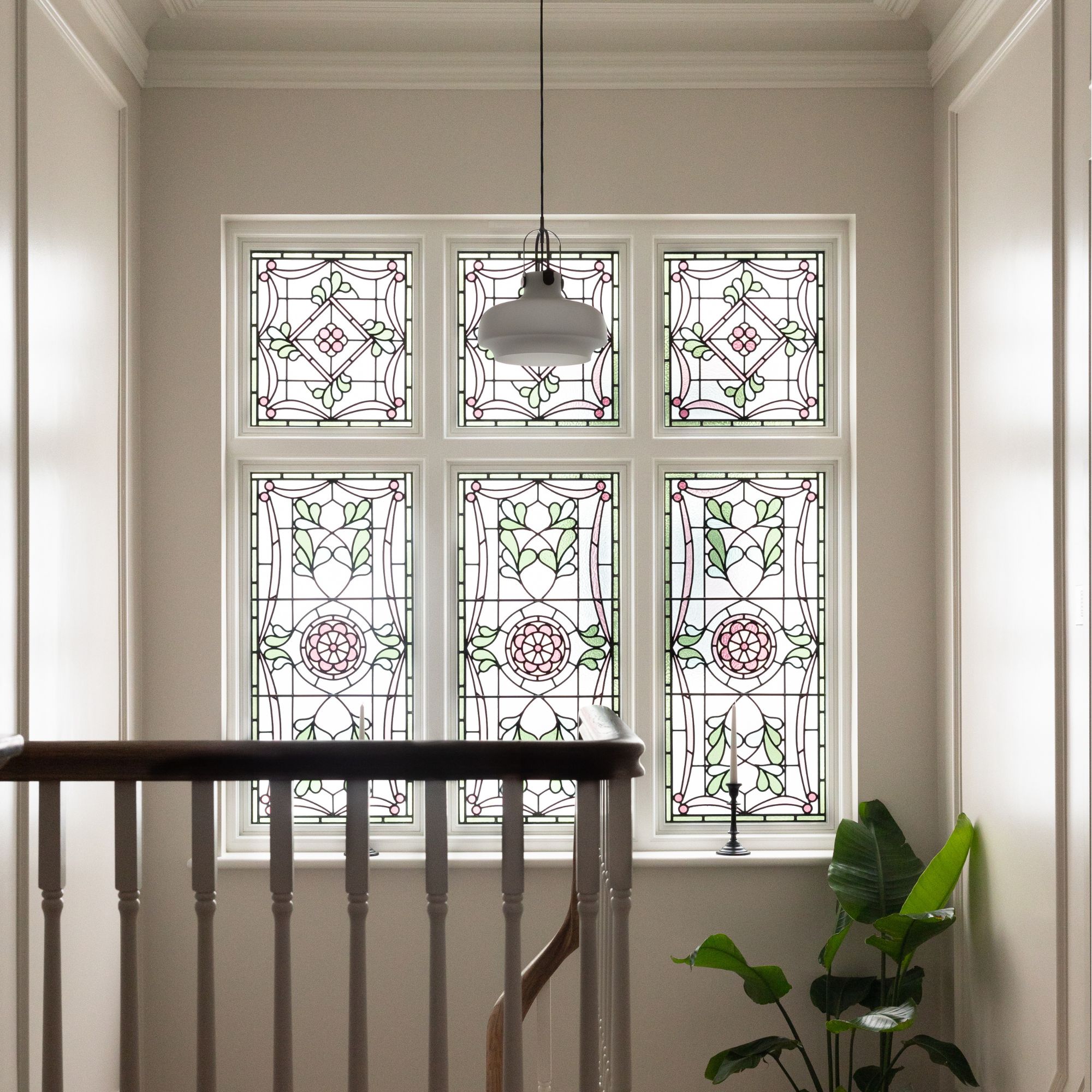 A large stained glass window on a staircase