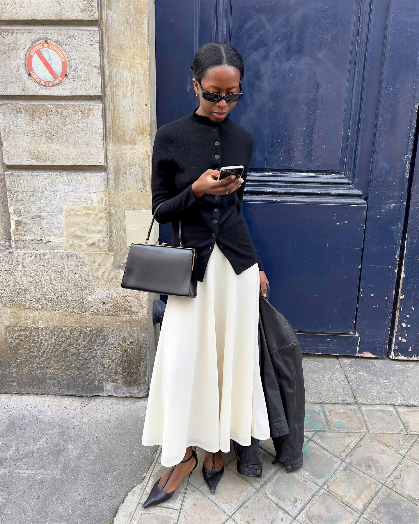 @sylviemus_ wearing a cardigan and long skirt.