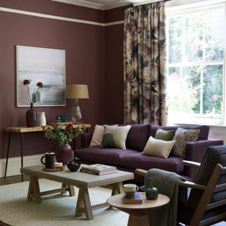 Brown living room with patterned curtains and sofa with cushions