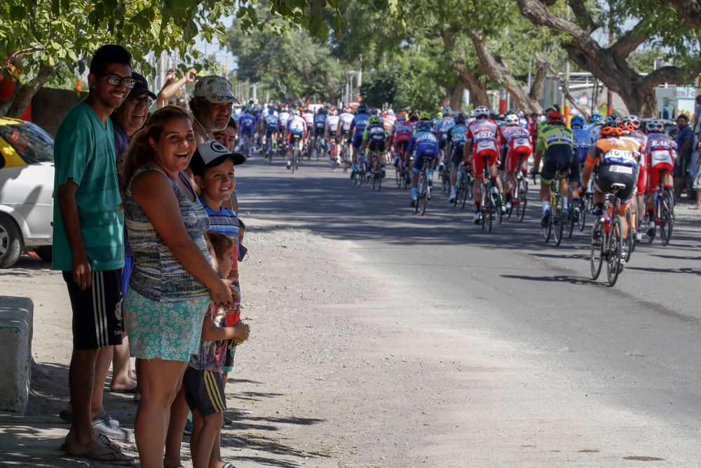 The local crowds cheer on the riders