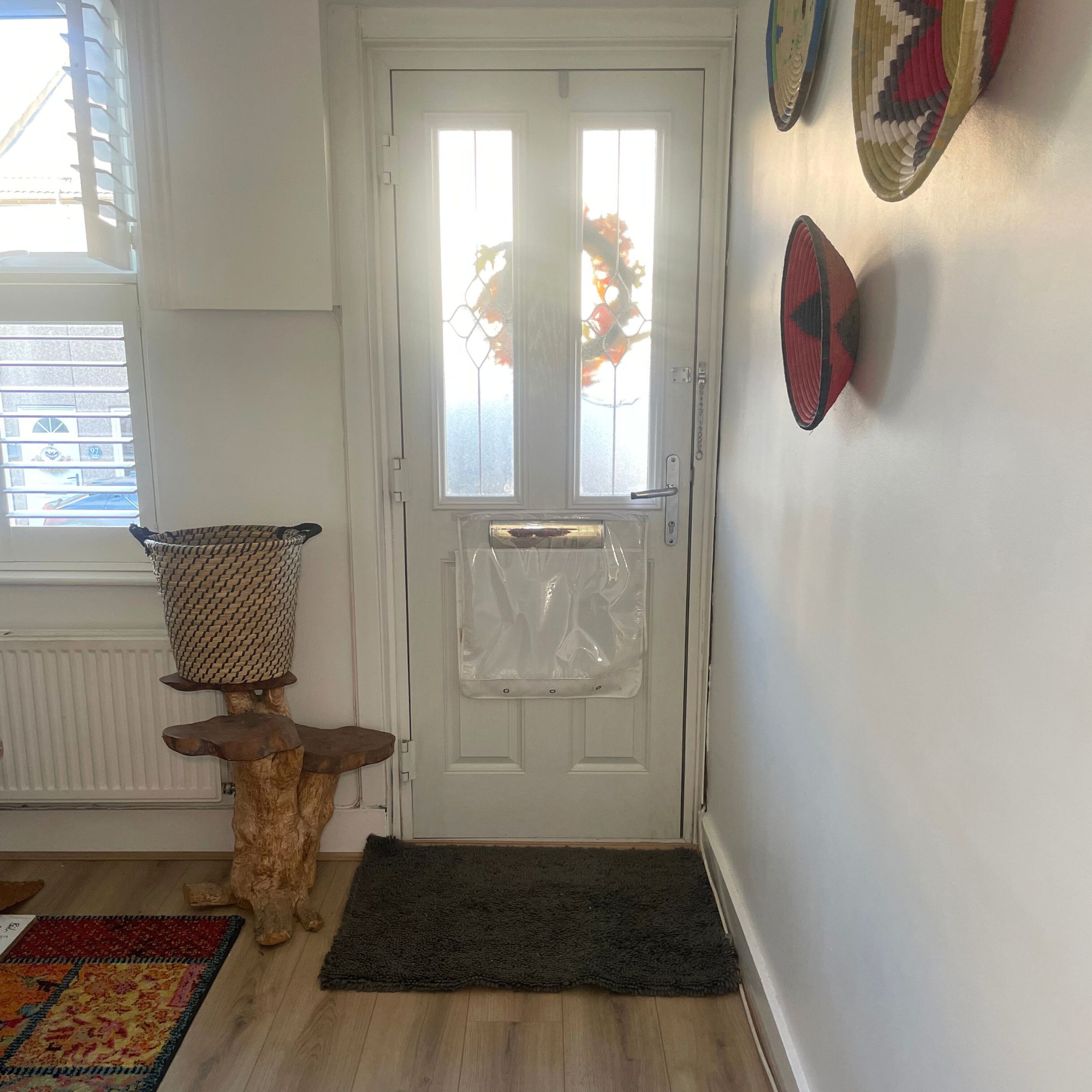 Dark grey Muddy Mat doormat in a white room