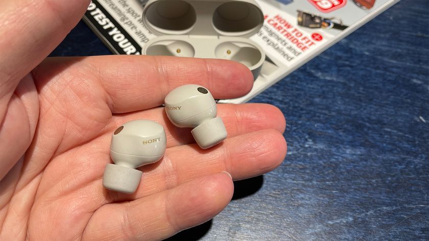 in-ear headphones: Sony WF-1000XM5 wireless earbuds held in hand