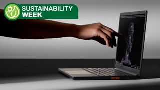 Framework Laptop 13 Pro shown from a side view with a finger touching the screen