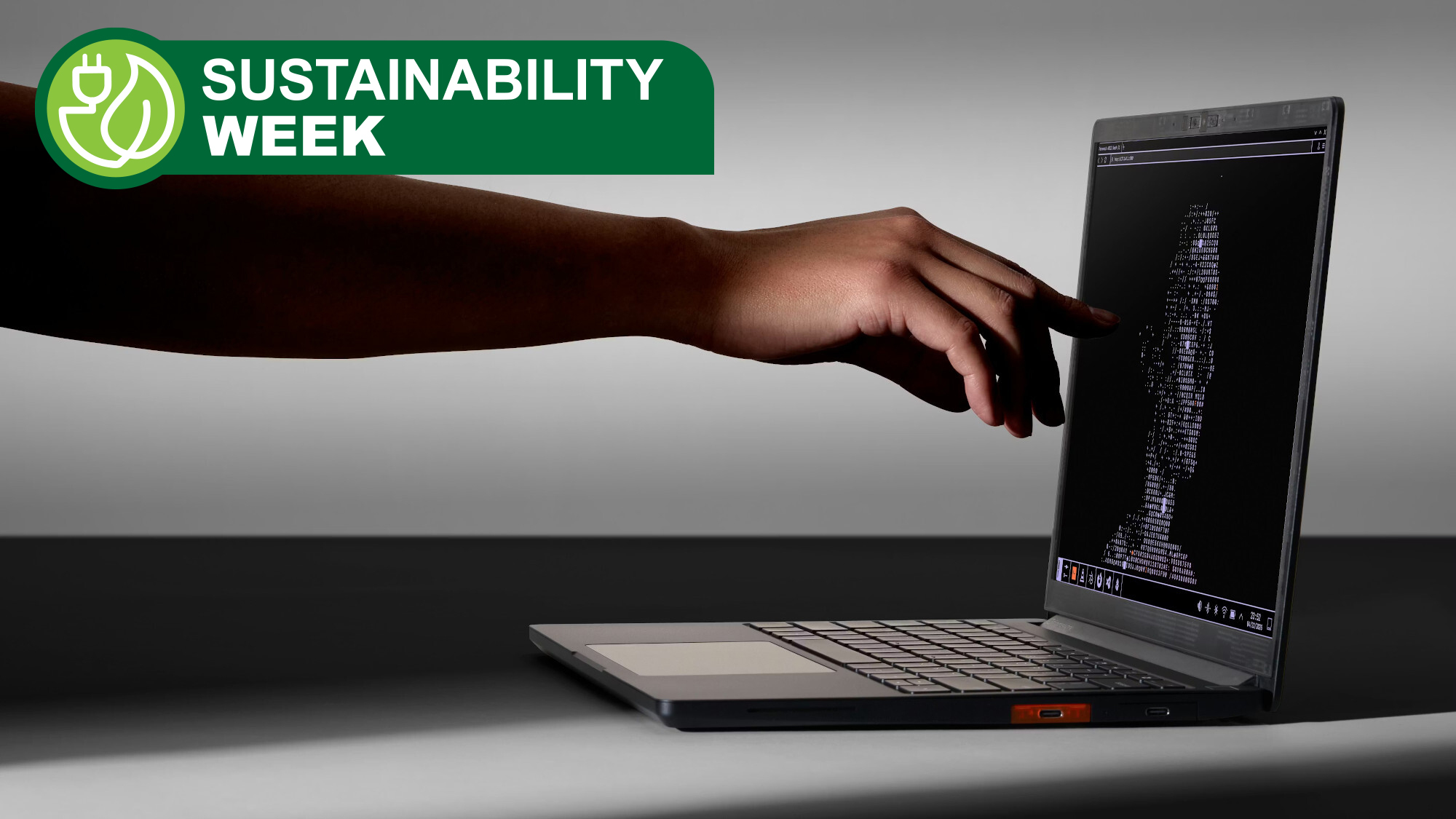 Framework Laptop 13 Pro shown from a side view with a finger touching the screen