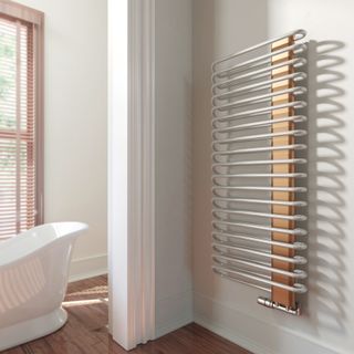 How to heat your home: contemporary spiral radiator in bathroom by frontline bathrooms