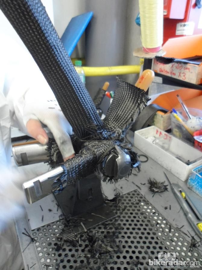 The bottom bracket shell uses 37 layers of woven carbon, all hand-stitched into place