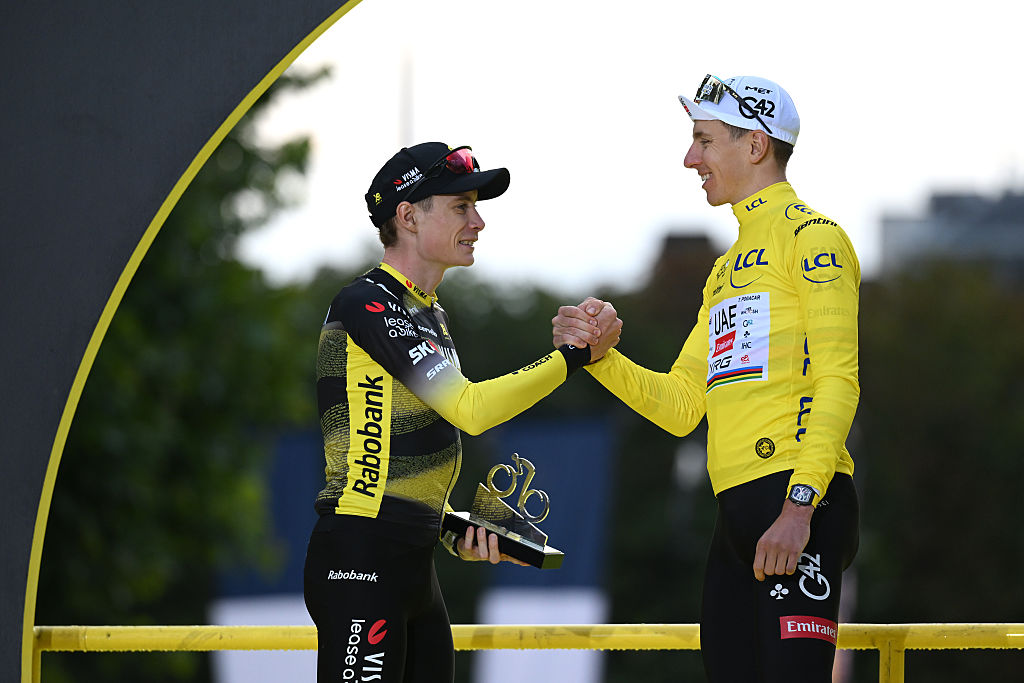 PARIS - CHAMPS-ELYSEES, FRANCE - JULY 27: (L-R) The second classified, Jonas Vingegaard of Denmark and Team Visma | Lease a Bike and final overall winner, Tadej Pogacar of Slovenia and UAE Team Emirates - XRG - Yellow leader jersey congratulate each other at podium during the 112th Tour de France 2025, Stage 21 a 132.3km stage from Mantes-la-Ville to Paris - Champs-Elysees / #UCIWT / on July 27, 2025 in Paris - Champs-Elysees, France. (Photo by Dario Belingheri/Getty Images)
