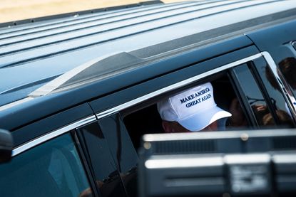 View of Donald Trump's hat as he exits his car.