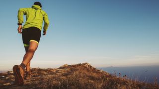 best trail running socks: A trail runner on a hilltop