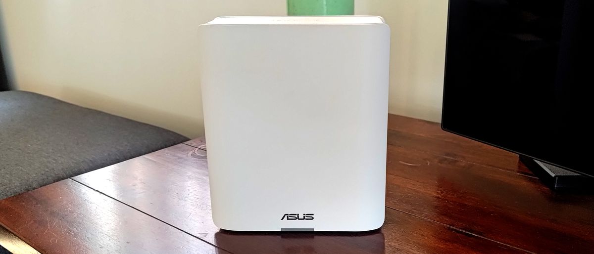 Asus ZenWiFi BT10 on a wooden table extra wide