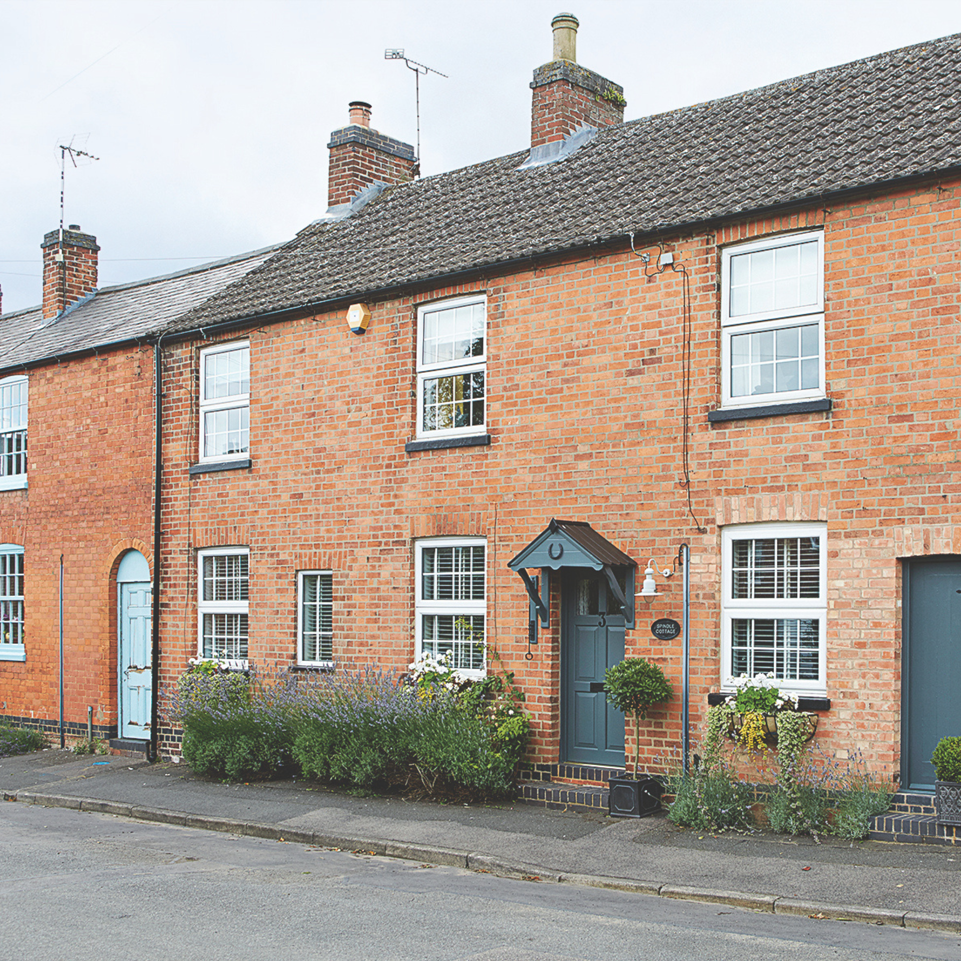 Row of terraced red brick houses.