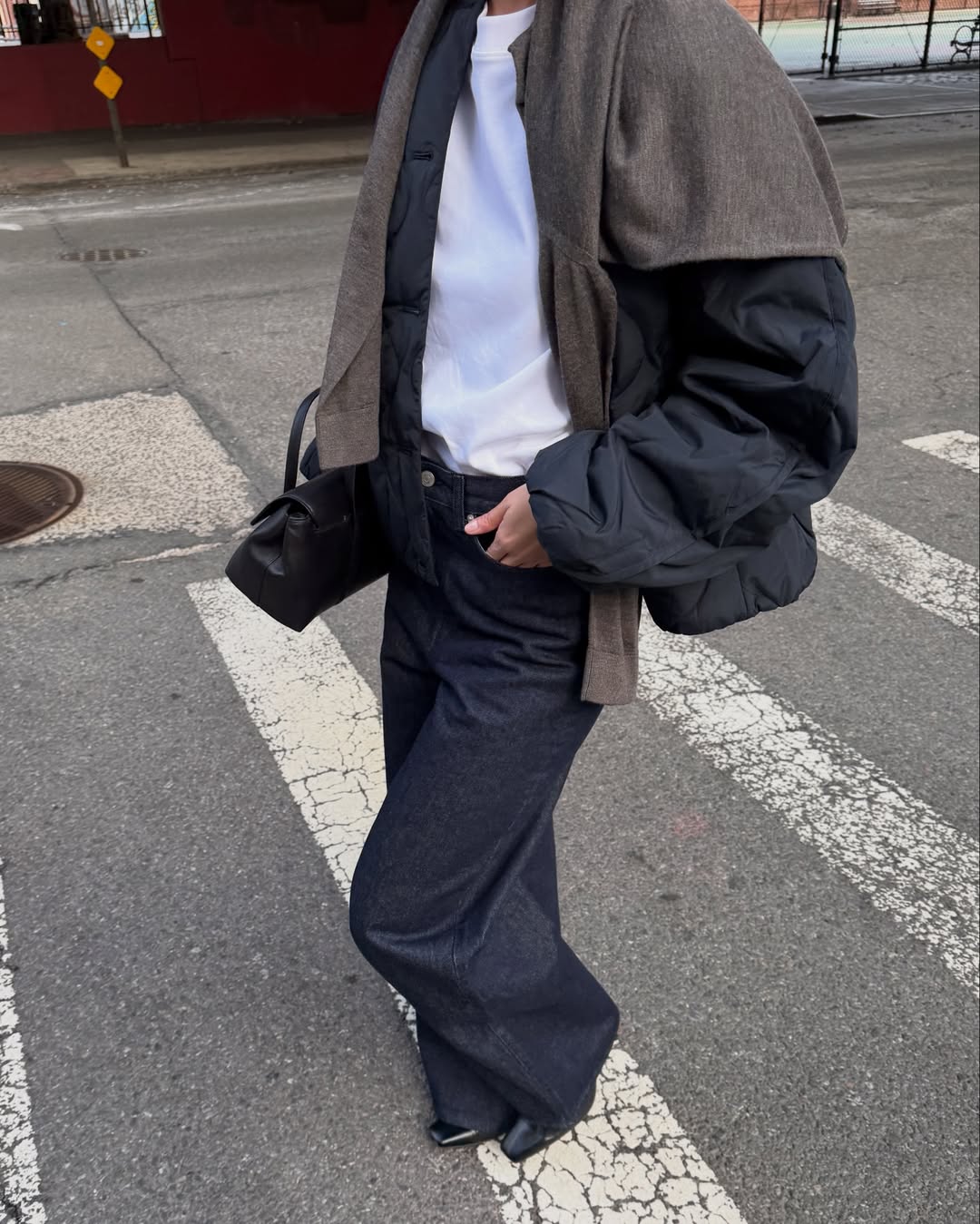 Mimi in dark wash jeans and padded jacket