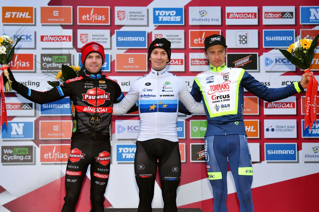 TABOR CZECH REPUBLIC NOVEMBER 14 LR Eli Iserbyt of Belgium and Team Pauwels Sauzen Bingoal on second place race winner Lars Van Der Haar of Netherlands and Team Baloise Trek Lions and Quinten Hermans of Belgium and TormansCircus Cyclo Cross Team on third place pose on the podium during the podium ceremony after the 25th Tabor UCI CycloCross Worldcup 2021 Mens Elite CXWorldCup on November 14 2021 in Tabor Czech Republic Photo by Luc ClaessenGetty Images
