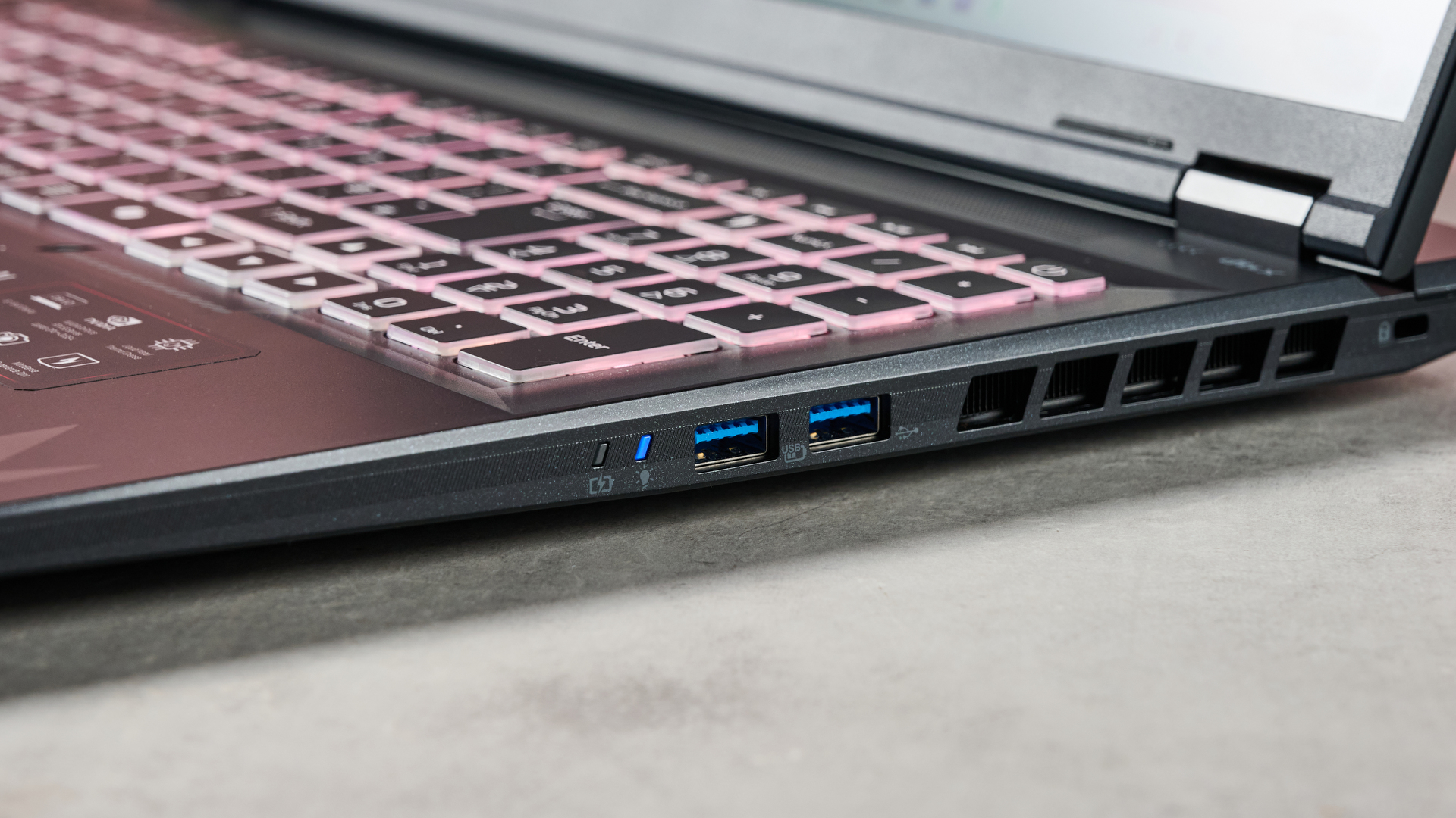 Close-up of right-hand ports on Acer Nitro 18 AI with keyboard backlighting on