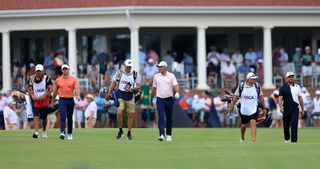 Rory McIlroy, Scottie Scheffler and Xander Schauffele walk down the fairway at the 2024 US Open