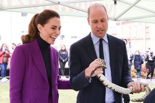 Prince George's parents Catherine, Duchess of Cambridge observes as Prince William, Duke of Cambridge handles a snake during their tour of the Ulster University Magee Campus on September 29, 2021 in Derry/Londonderry, Northern Ireland.