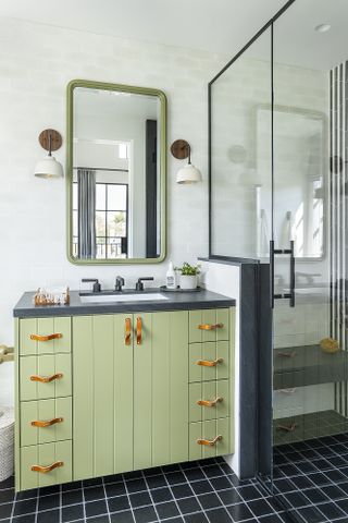 bathroom with shower and green vanity with drawers