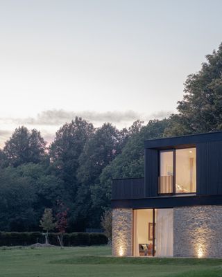 capability house with minimalist interiors of stone and timber and a twisting metal staircase