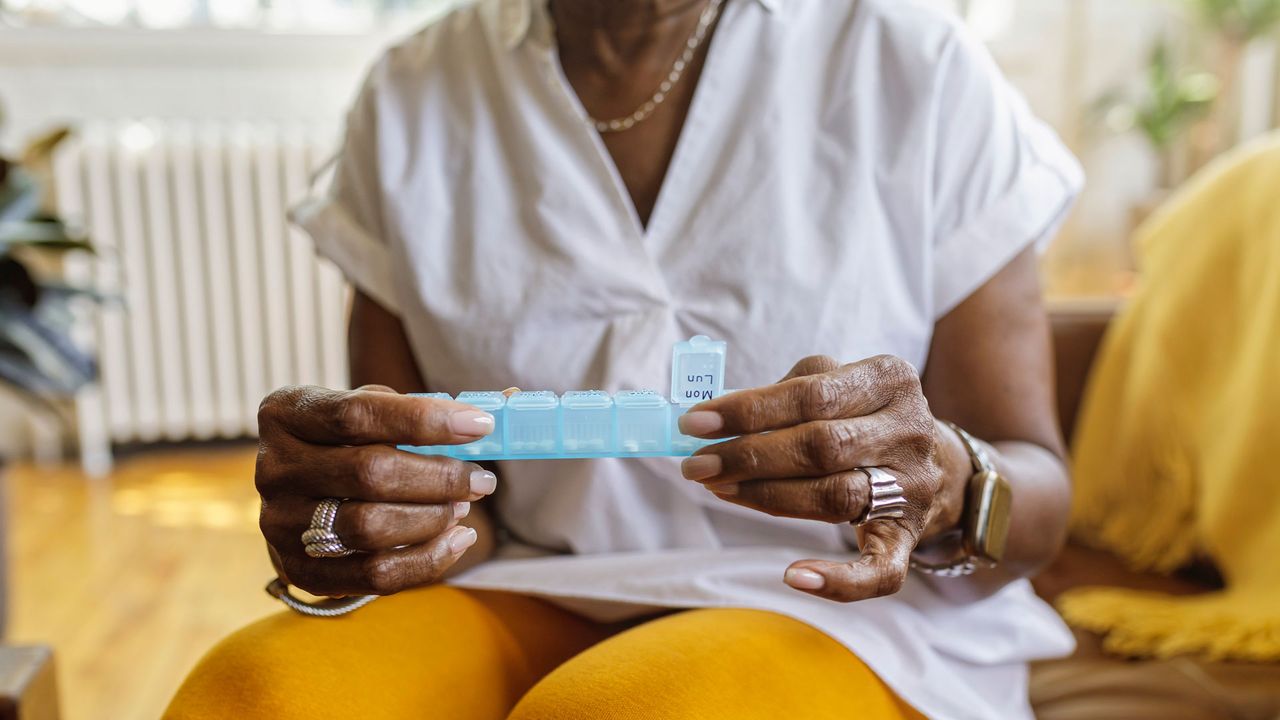 Woman holding pill box