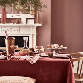 Dining room with pink walls and tablescape scheme.