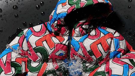 Colourful Herno Globe bomber jacket with letters being splashed with water