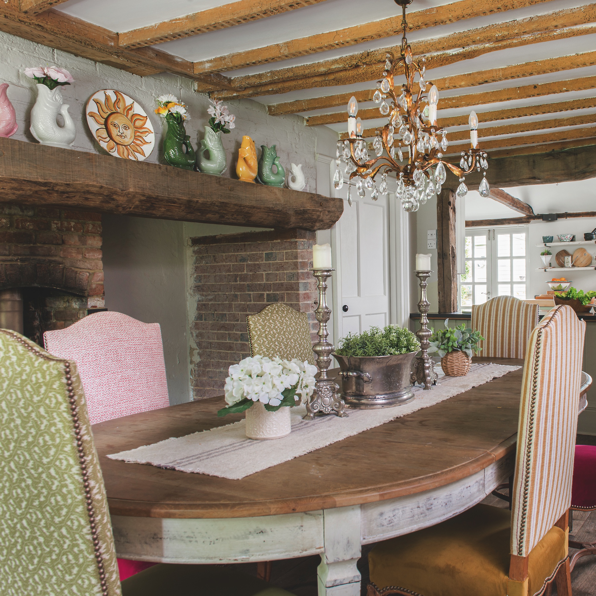 dining table with upholstered chairs in 18th century dining room with inglenook fireplace