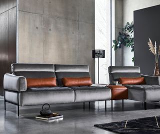 grey sofa in room decorated with polished concrete walls and floor