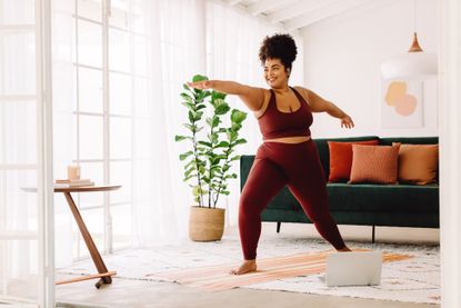 PCOS treatment: A healthy woman doing yoga in her living room