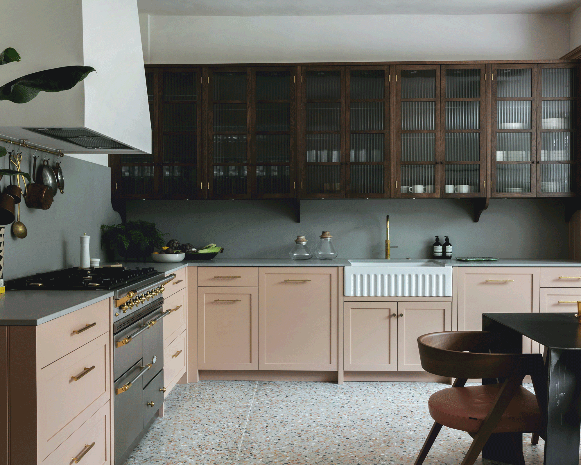 Two-tone kitchen with pink and timber cabinetry