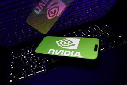 A binary code displayed on a laptop screen and Nvidia logo displayed on a phone screen