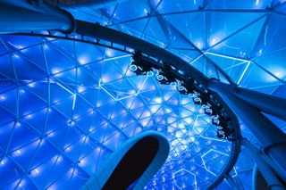 a roller coaster lit up in blue lights