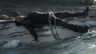 Daryl strapped to the bottom of a boat in The Walking Dead: Daryl Dixon