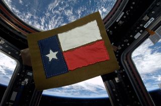 ISS Expedition 37 flight engineer Karen Nyberg sewed this Texas flag from fabric she cut from t-shirts she wore in space.
