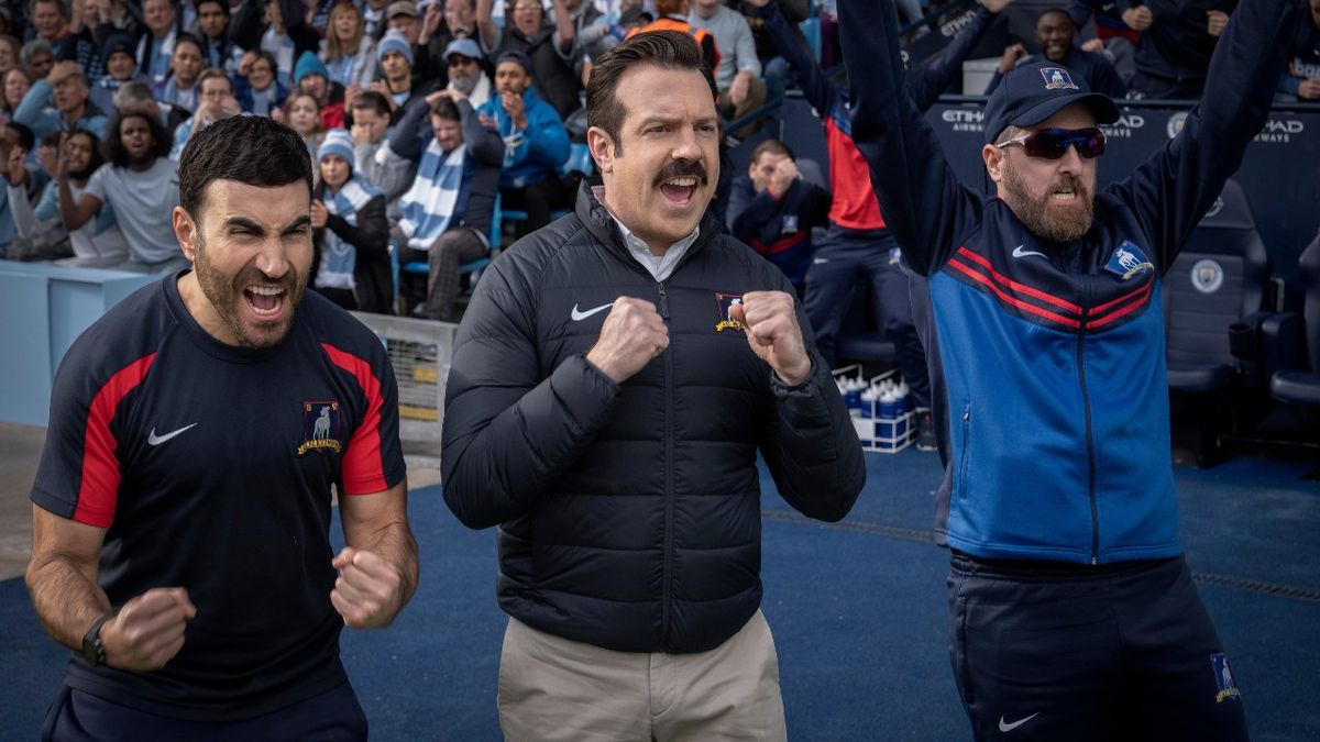 From left to right: Roy Kent, Ted Lasso and Coach Beard all cheering.