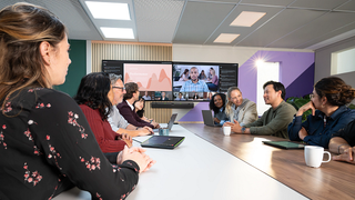 A videoconference taking place in a conference room.