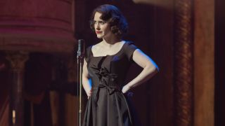 Midge Maisel standing with her hands on her hips.