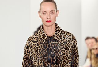 Amber Valletta modeling a leopard-print coat at the FW24 Michael Kors show.