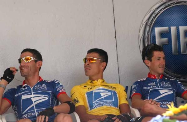 Victor Hugo Pena is in yellow with Hincapie by his side